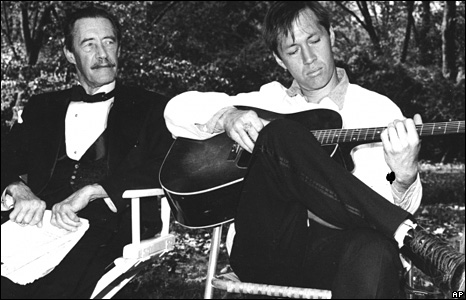 John Carradine watches his son David Carradine play the guitar sometime in the mid 1960s.