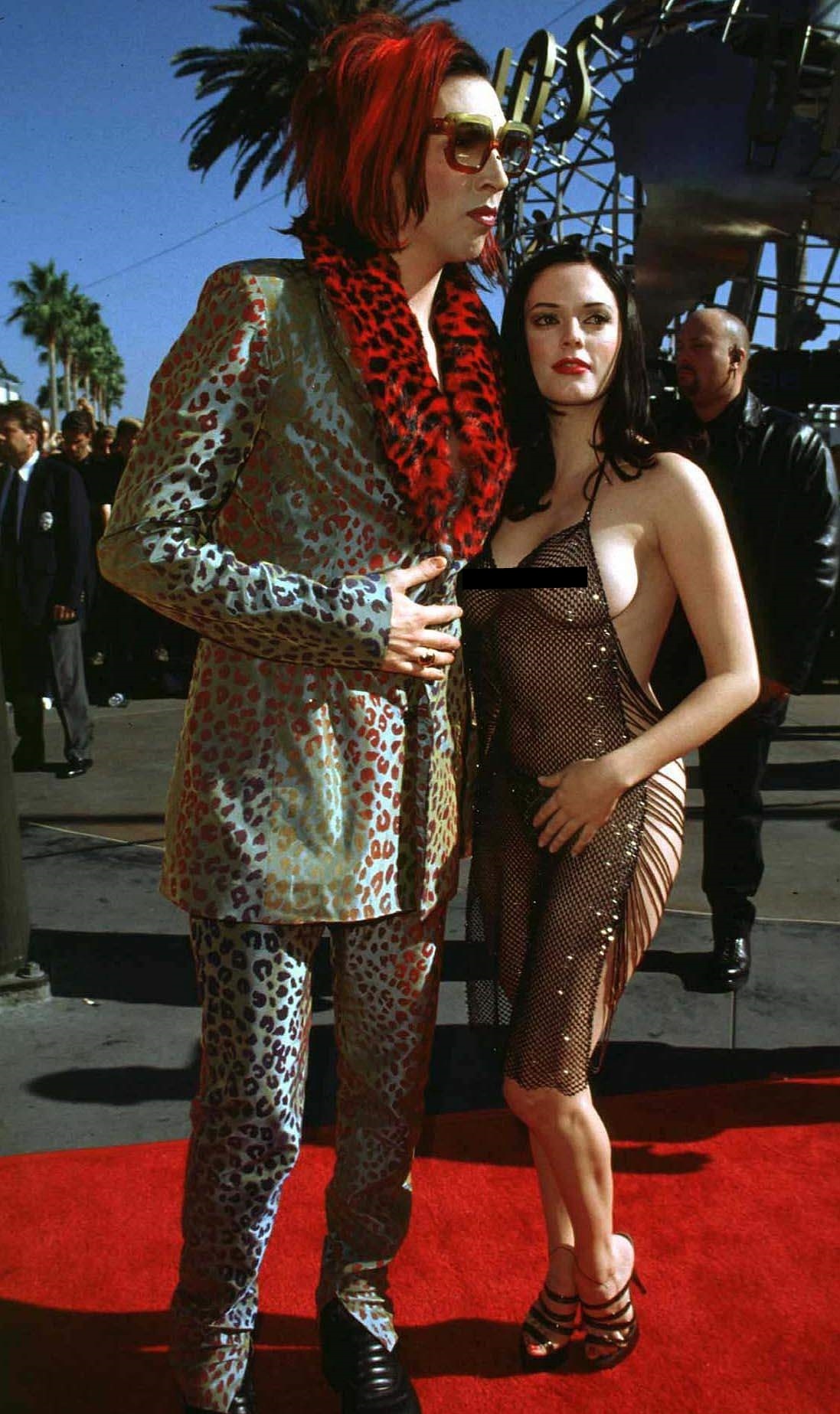 Marilyn Manson and his then girlfriend Rose McGowan arrive for the VMAs in 1998. McGowen was starting to make a name for herself as an actress when she showed up practically naked to a televised music awards show. Virtually her entire exposed ass and completely see through dress made major headlines at the time and shocked the other attendees.