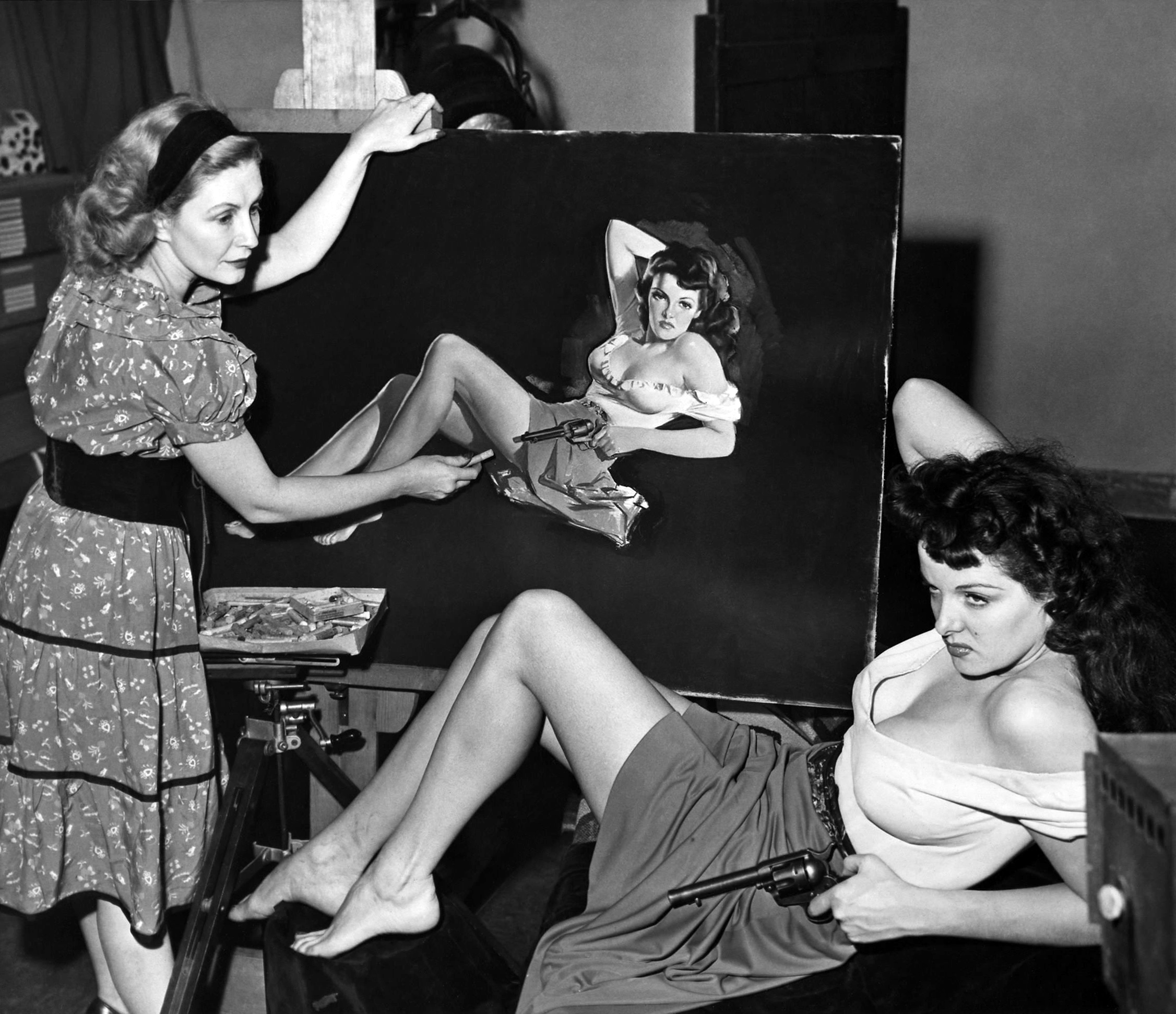 Jane Russell poses for artist Zoë Mozert who was making a chalk drawing for the infamous publicity poster for the film The Outlaw in 1941. The film was released 2 years later, making Russell a star.