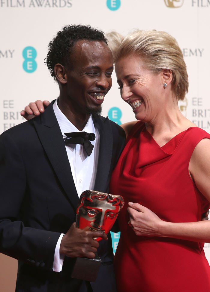 Barkhad Abdi and Emma Thompson laugh while posing for pictures after Abdi had won a BAFTA award for his role in Captain Phillips in 2014.