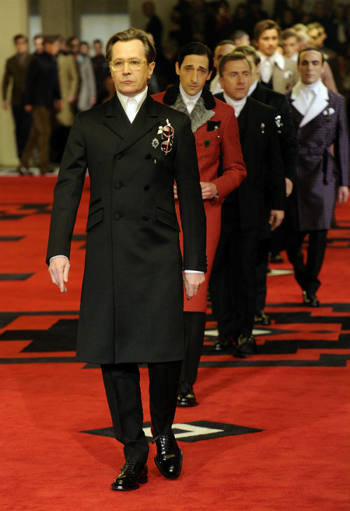 Gary Oldman leading Adrien Brody, Tim Roth, Garrett Hedlund, Jamie Bell, Emile Hirsch, and Willem Dafoe and numerous male models for the Prada Men's Collection premier in Milan in 2012. Unlike the others, Oldman stuck to his character as a dead eyed male model and did not smile once throughout the event.