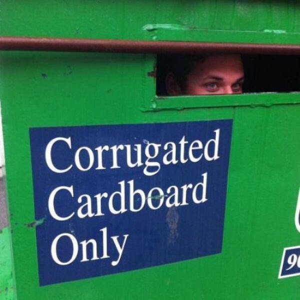 Corrugated card board only sign with a person inside it.