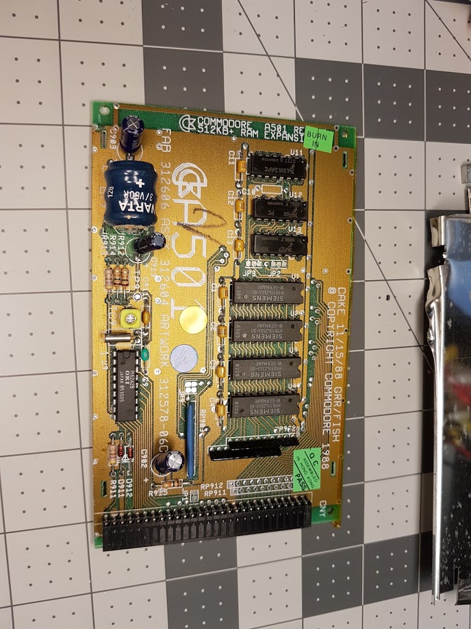 "Opening up the computer with the non working clock, it has the Commodore A501 RAM+clock board. It is encased in metal shielding so I cut that away to get inside."