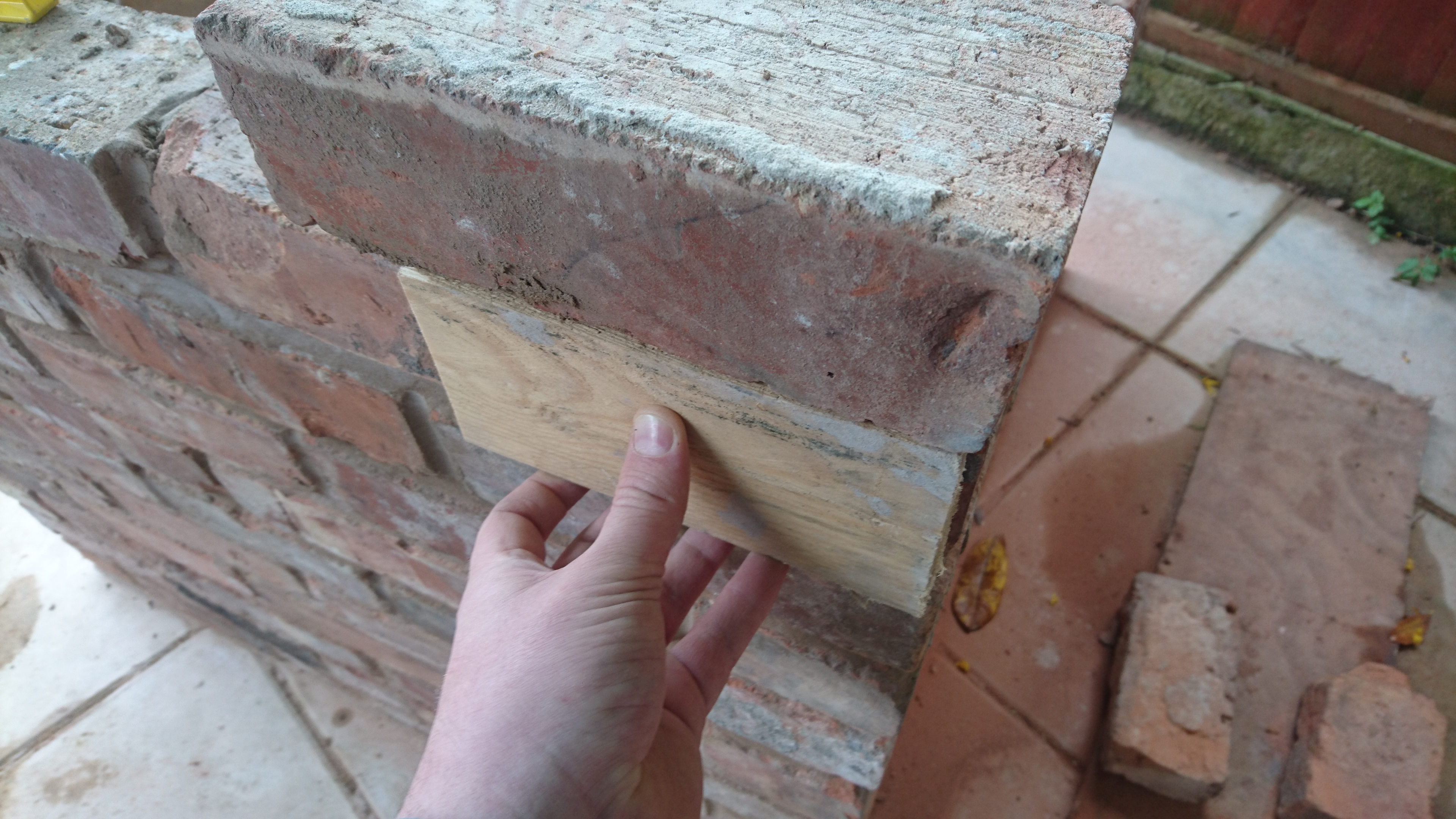 "To corbel out, the easiest way I found was to use a piece of 1" wide wood as a template. Sit the brick so it is flush with the template, on both sides ensuring the brick is level too."