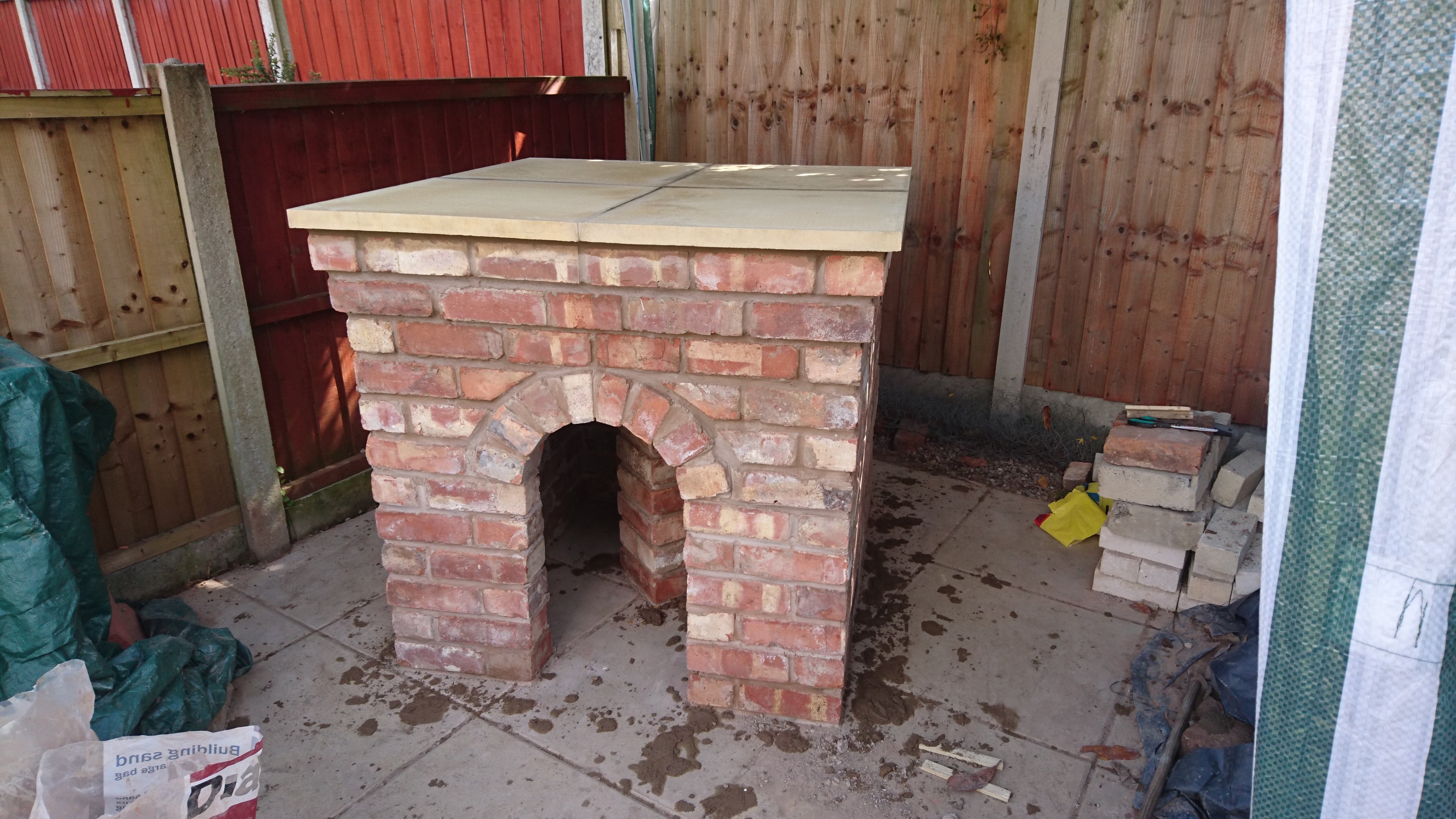 "Now the paving flags sit on top for the hearth. Looking good so far! Time to fill the wood storage up."