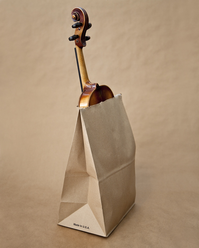 Violin in a brown paper bag