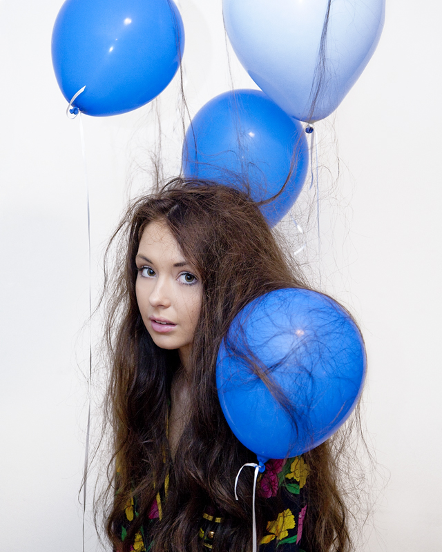 Girl with lots of static cling from the balloons around her
