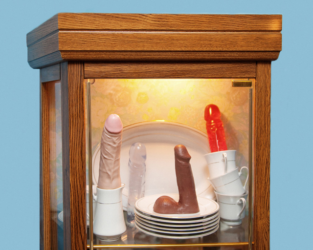Several dildos in a kitchen cabinet.