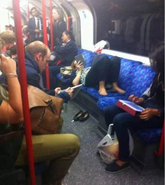 Woman chilling out and lady lounging on public transportation as other people are forced to stand.