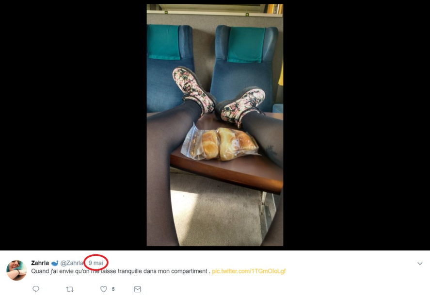 Picture of a woman riding public transportation and has her feet up on the opposite seat.