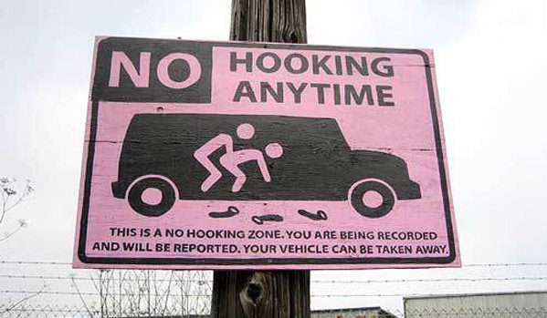 Very graphic street sign explaining that HOOKING is illegal at this location.