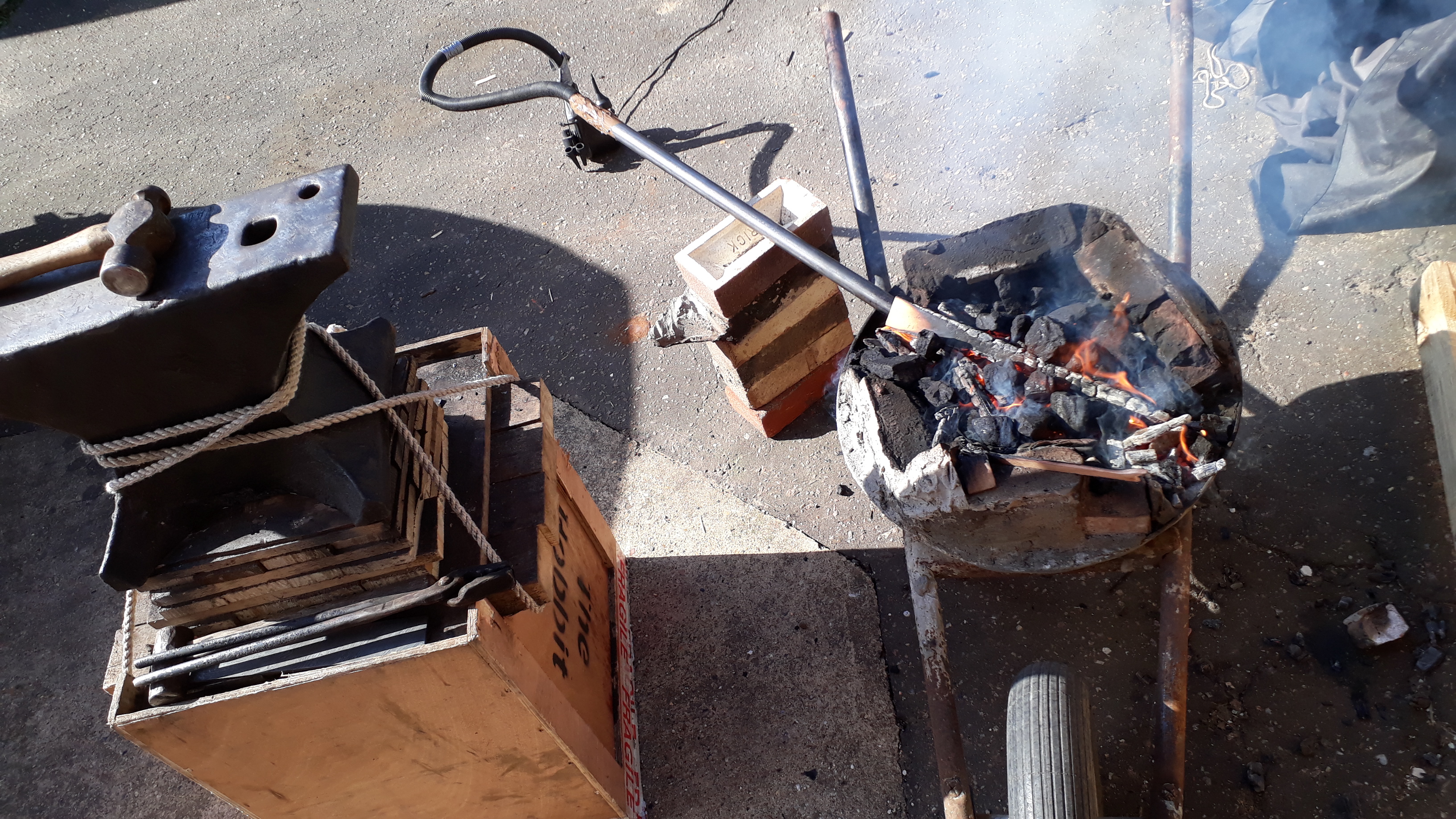 "I fired up my forge, which is called Dolores. Yes, it's a bin lid on a wheelbarrow with some cement and an inflatable mattress pump. And it works!!!"