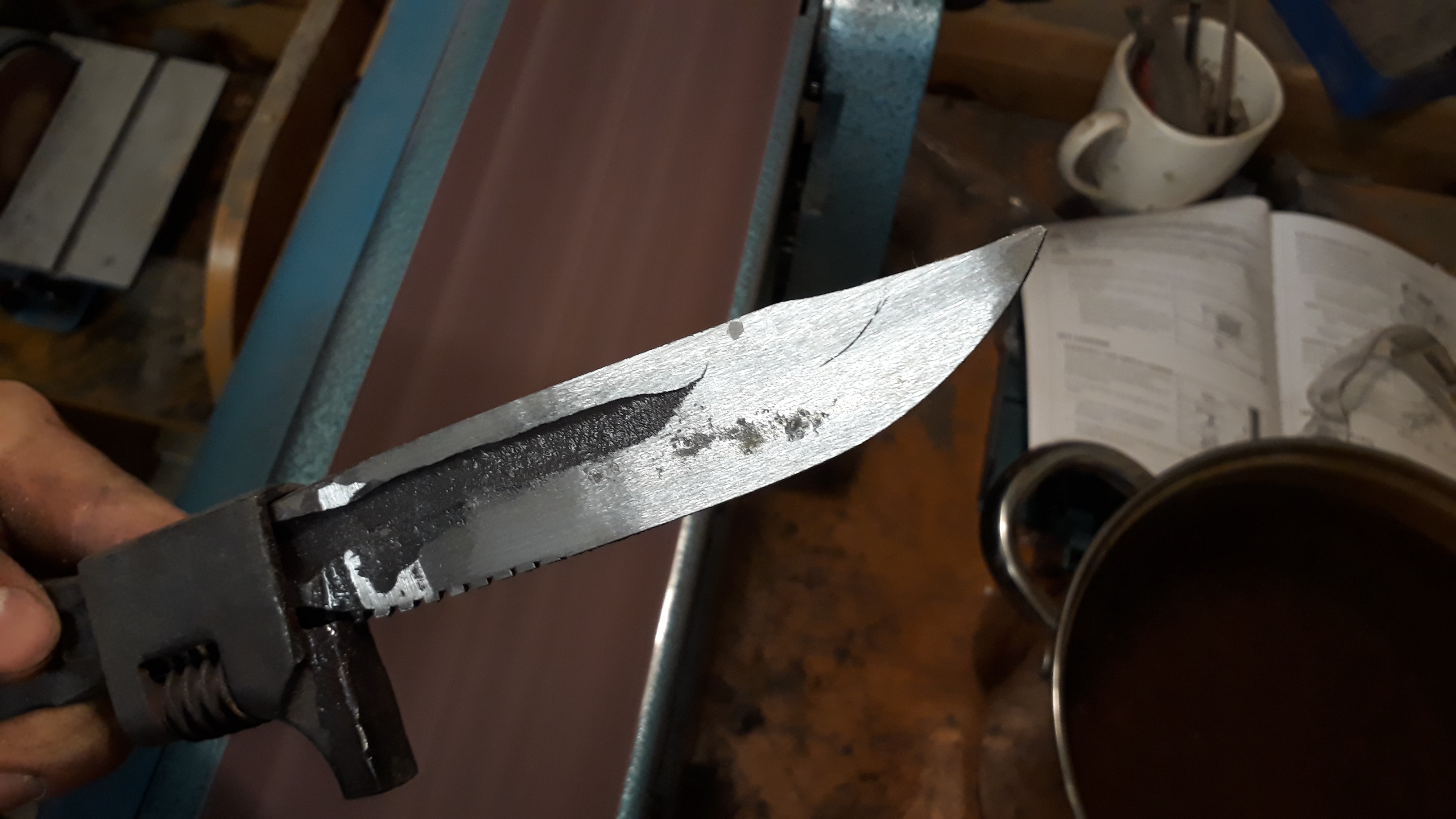 "Rough grinding the blade to shape on the belt sander. Shortly after, I welded a few spots between the blade and grip-guard to stop it rattling."