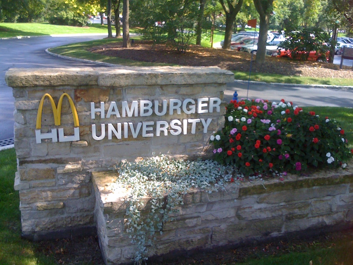 We start easy with the Hamburger University. It's a 130,000-square-foot training facility of McDonald's, located in Oak Brook, Illinois, a western suburb of Chicago. This corporate university was designed to instruct personnel employed by McDonald's in the various aspects of restaurant management. More than 80,000 restaurant managers, mid-managers and owner/operators have graduated from this facility. This "prestigious" school was founded in 1961.