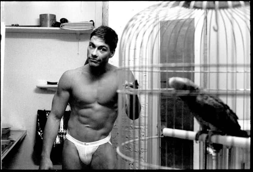 Jean-Claude Van Damme (real name Jean-Claude Camille François Van Varenberg) hanging out in his apartment in Brussels, Belgium, in 1982. The following day the Belgian would win a bodybuilding contest. He decided to move to the US to try and become an action star. He had confidence as he was already an experienced black belt in karate, which he has been doing since he was 10, as well as an accomplished ballet dancer, which he has been doing since he was 16. Couple interesting notes, Van Damme was the original Predator, before they abandoned it and went with Kevin Peter Hall who was a bigger, stronger, and more imposing looking Predator. He also purposely gouged an extra's eye in 1989 during a film and was sued for it. He has had alcohol problems, including being sentenced to 3 years probation for it, and has been married 5 times. His latest wife, Gladys Portugues, he actually married for 5 years until 1992, then remarried in 1999. He has 3 children.