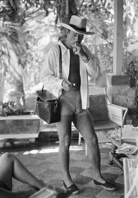 John Wayne feeling the pressure while vacationing in Mexico in the mid 1940s. John Wayne virtually never wore shorts anywhere, which is probably why they don't look comfortable on him in this picture.
