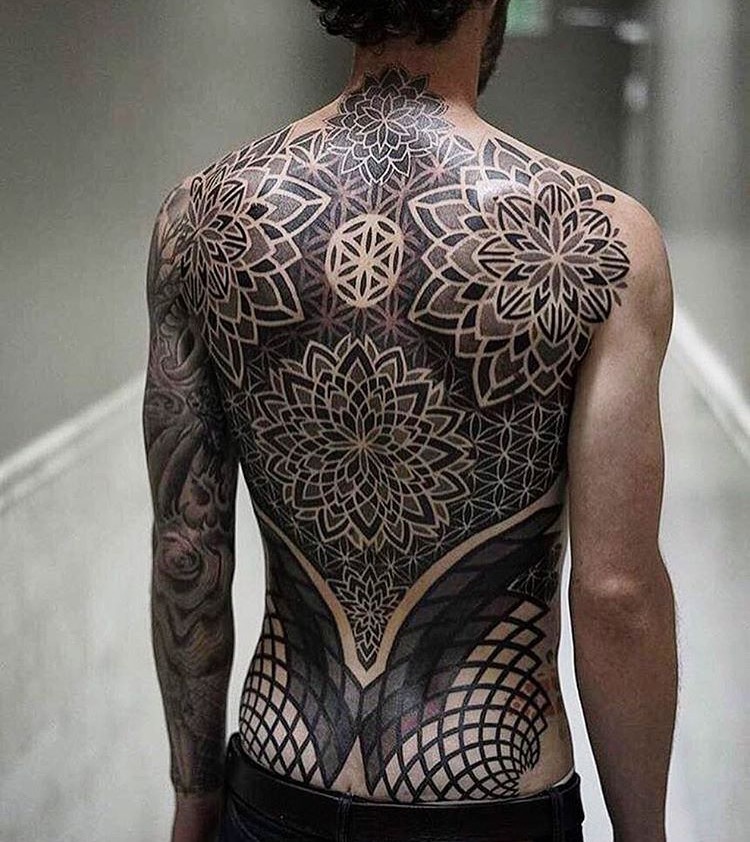 Man with elaborate complex pattern tattooed on his back