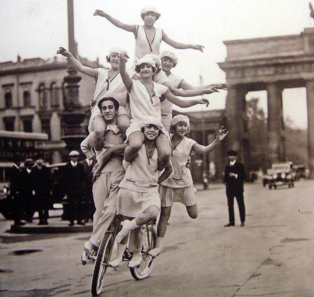 A family of acrobats perform on a street in Berlin, Germany in 1920.