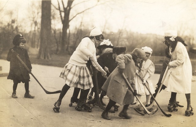 Young girls play roller hockey on the street somewhere near Toronto, Canada in 1922. Notice how some children don't have roller skates (probably couldn't afford them) but are allowed to play regardless.