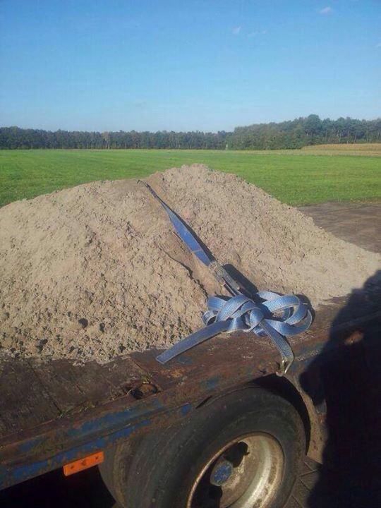 Pile of dirt strapped down to a trailer