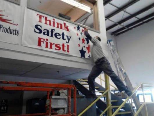 Taking down the Think Safety First sign without any safety in mind.