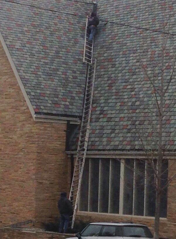 stacked ladders to climb the roof