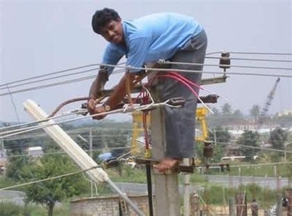 Indian man borrowing energy from the power lines.