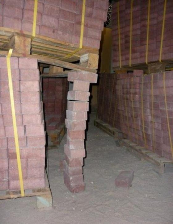 pallets of bricks stabilized with a stack of bricks.