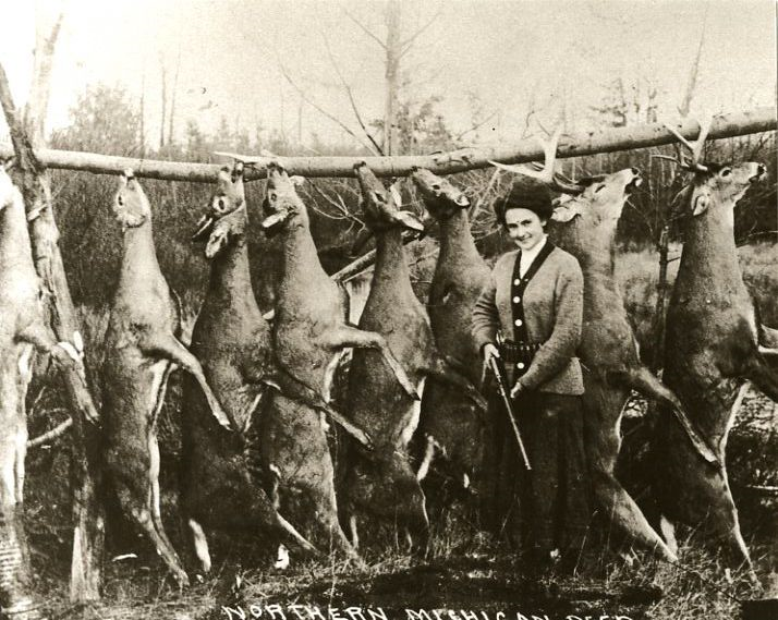 A unnamed woman shows off her hunting skills in Michigan, 1927.