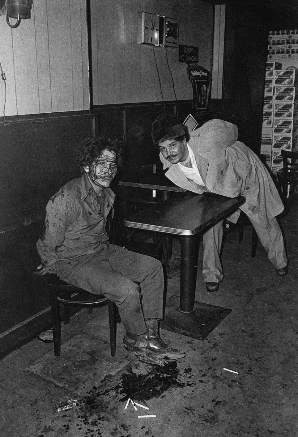 2 Men arrested after a bar fight pose for a picture in NYC, 1975.