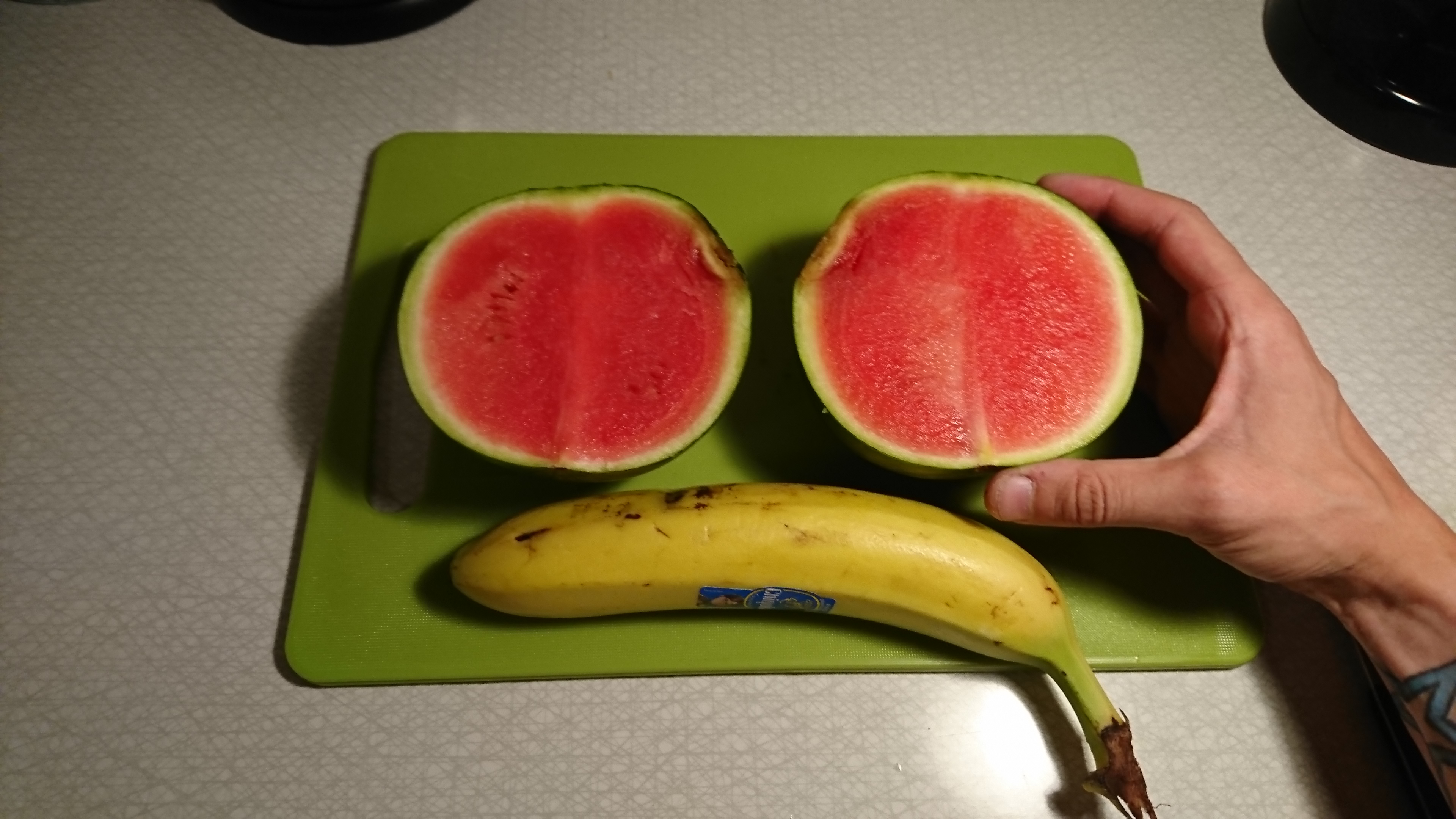 "I wanted to find out what this tiny melon looked like on the inside, oh, banana for scale again, can't forget that."