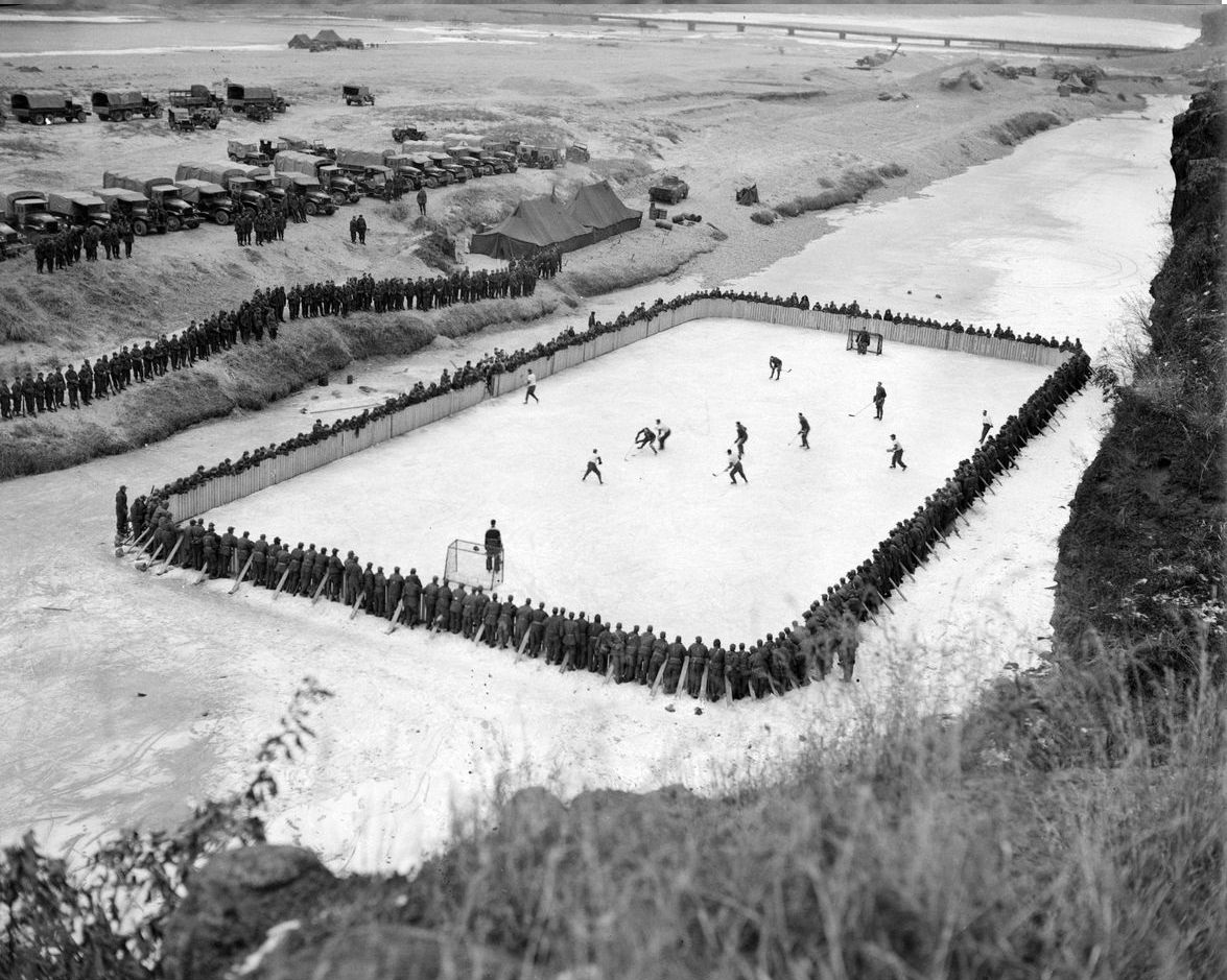 Canadian troops play hockey on the frozen Imjin River in Korea during the Korean War in 1952. The photographer noted how you can hear artillery fire in the background during the entire game. Apparently Canadian soldiers never invade a foreign land without bringing Hockey sticks, pucks, skates, and pads.