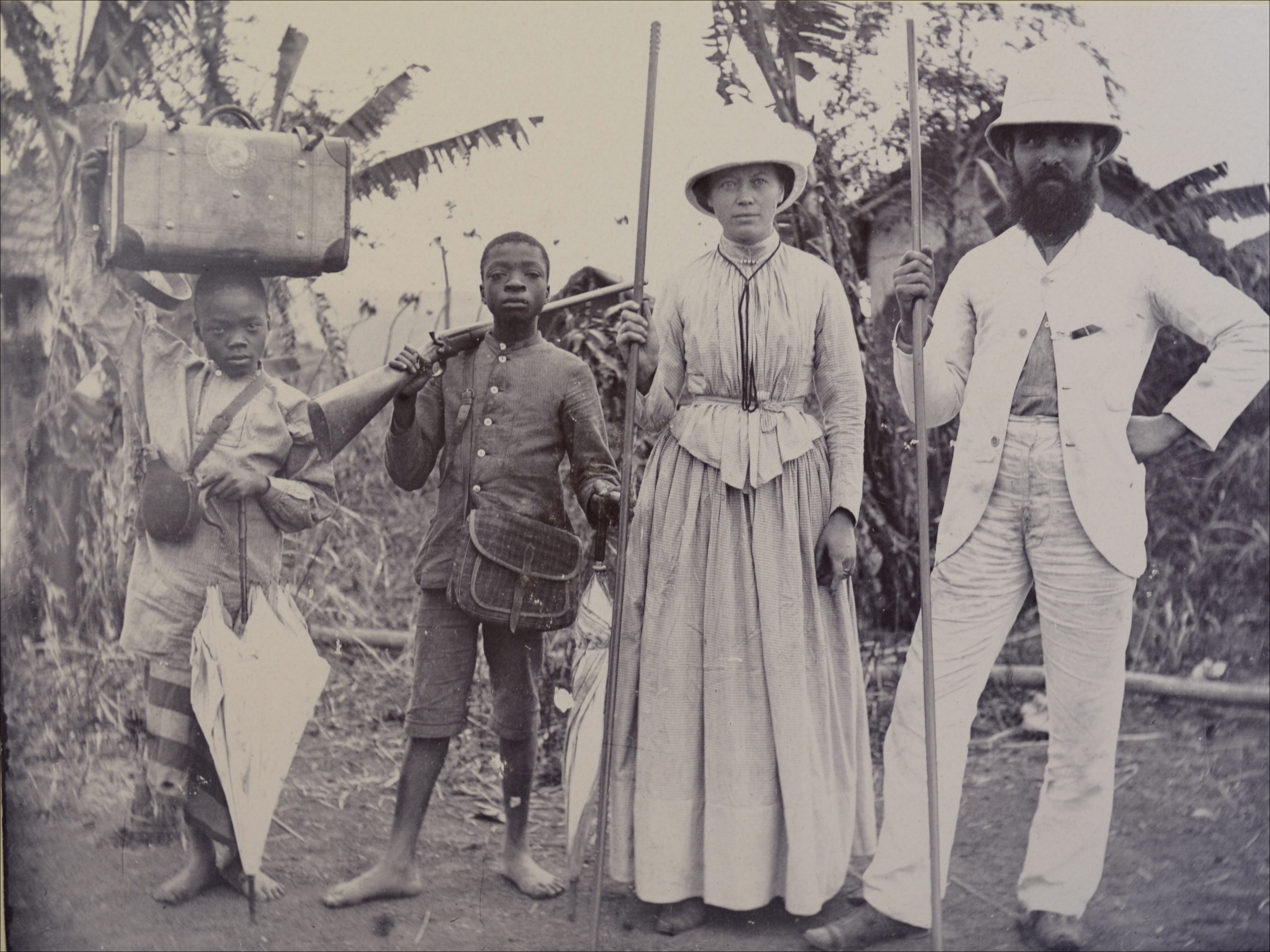 2 unnamed Swedish Missionaries pose for a picture with 2 young locals assisting them in lower Congo in 1888.