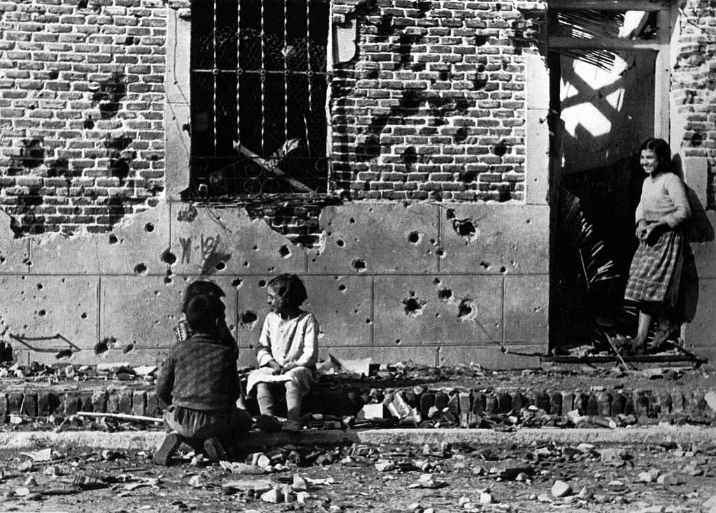 Children play on a war torn street in Madrid, Spain in 1936 during the Spanish Civil War. The war would last another 3 years, and was not only major for Spain of course but the world, as many countries including Nazi Germany, the UK, and France sent advisors and watched the fighting play out with modern weapons.