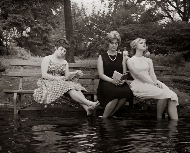 Women move a park bench into the water to keep cool on a hot day in Central Park in NYC, US in 1961.