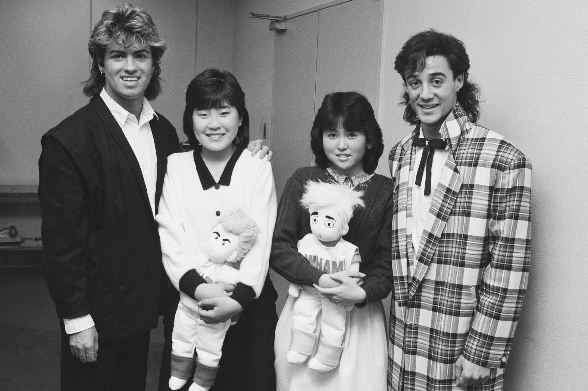 George Michael and Andrew Ridgeley of Wham! with two fans during their 1985 world tour in Japan.