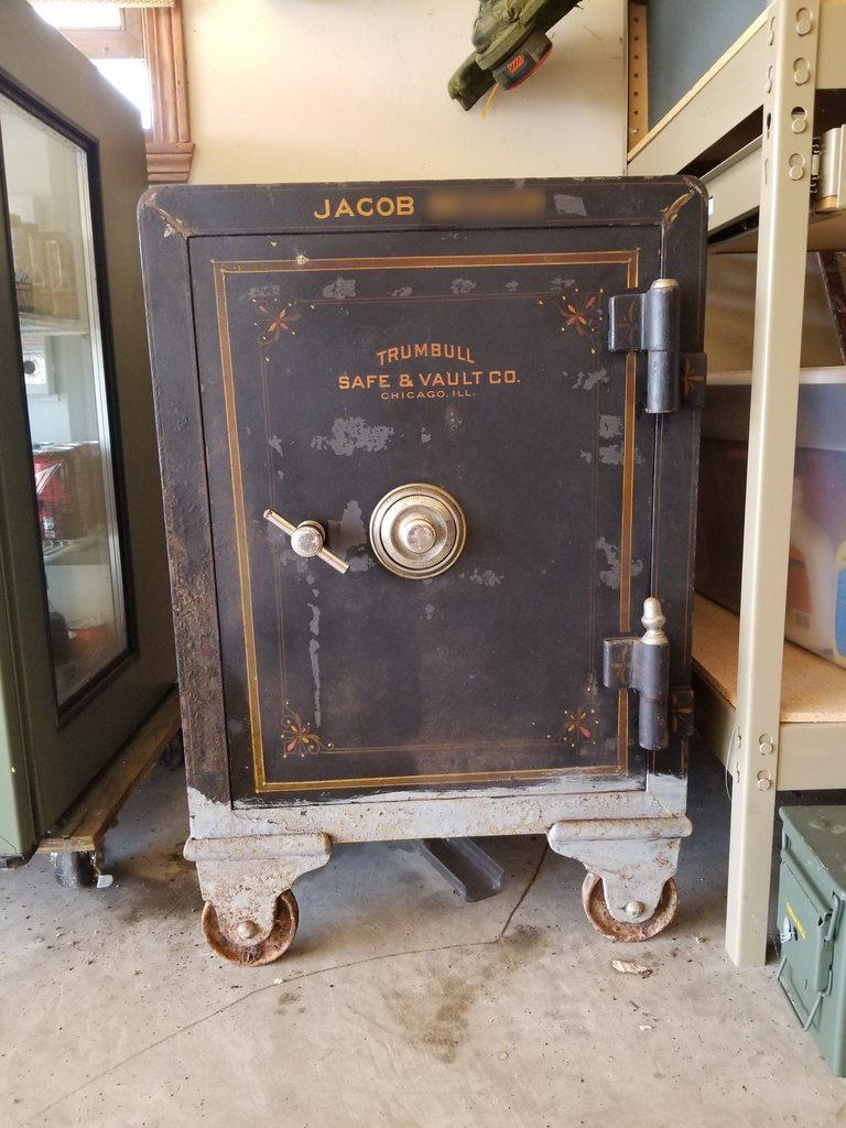 Close up of old safe on wheels.
