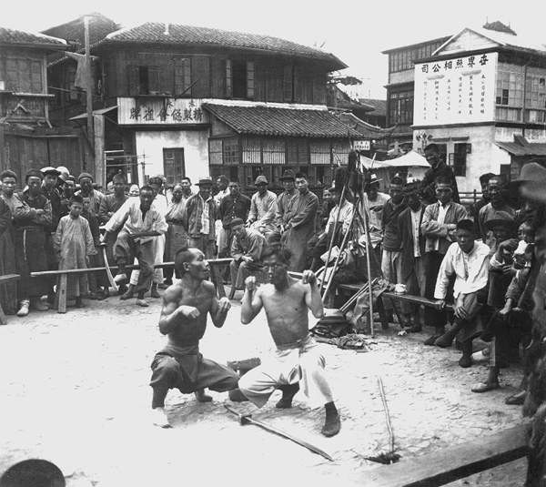 Street performers imitate animals as part of their act in Shanghai, China, in 1929.
