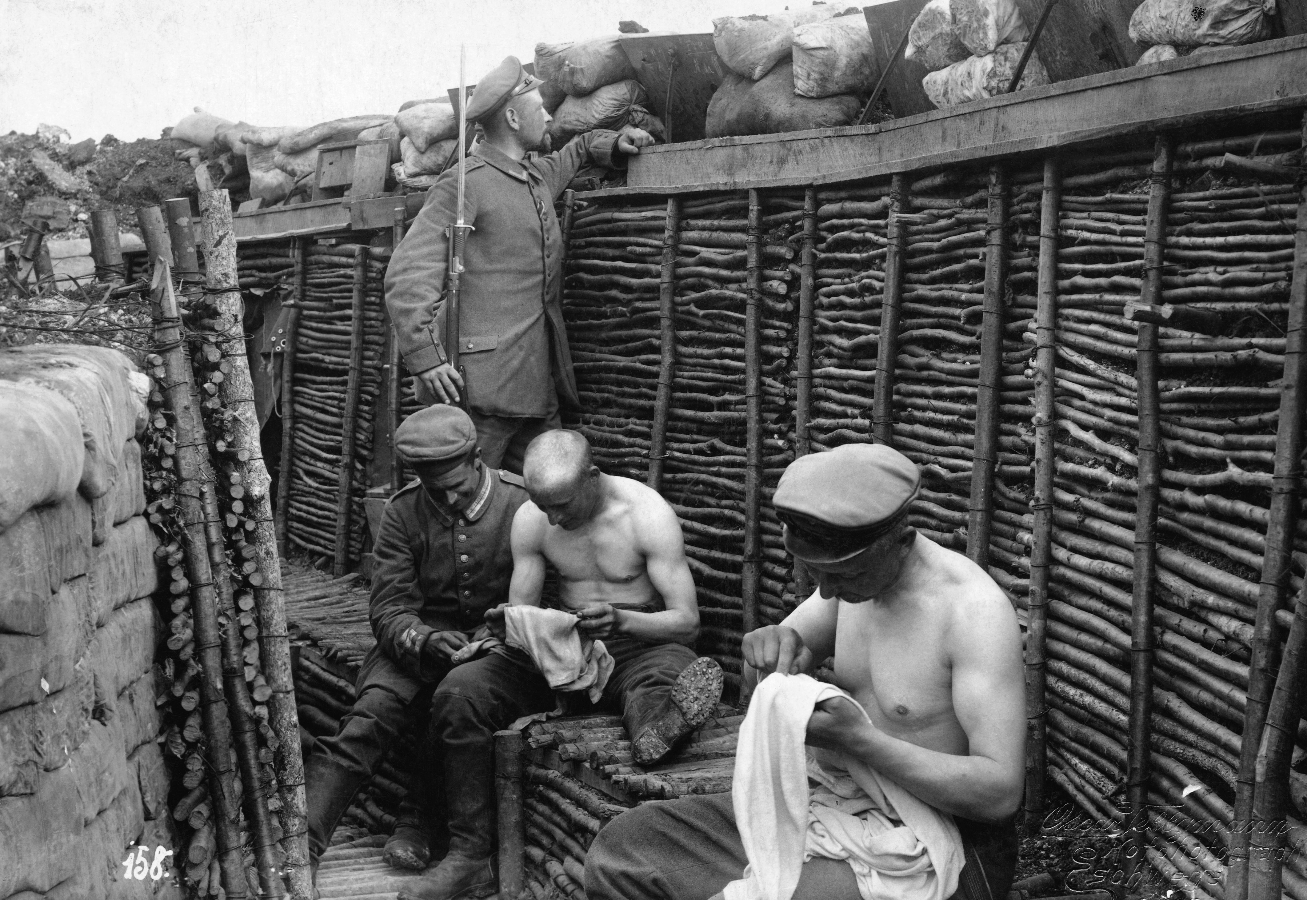 German soldiers in their trench picking lice out of their clothes during a quiet moment somewhere on the front in Northern France in 1916. On both sides soldiers had to endure unimaginable things just while in the trenches. Lice, rising water in the trenches causing trench foot, infections, colds, and numerous other ailments were brutal to soldiers at times.