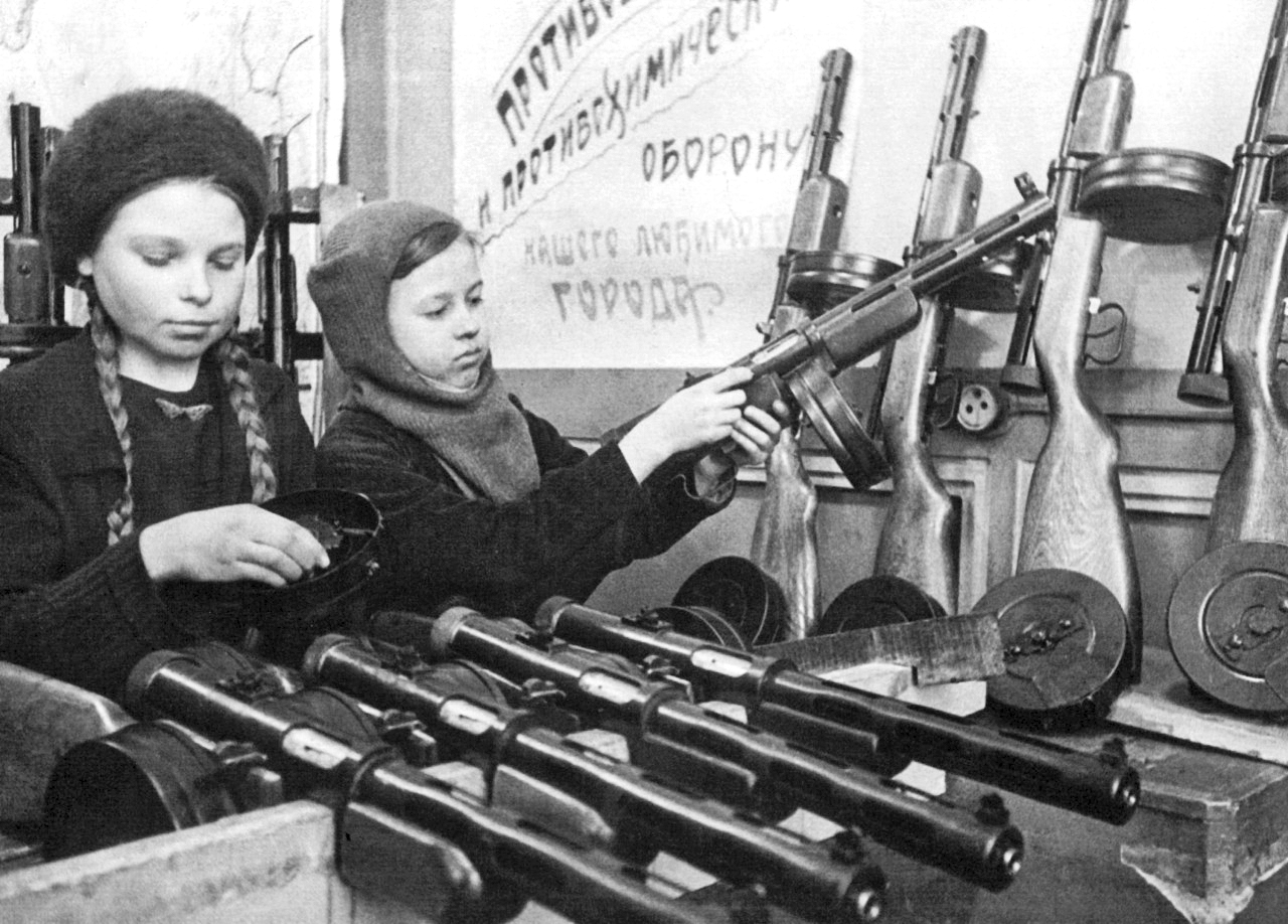 Two young girls assemble weapons from a supply drop during the Siege of Leningrad in the USSR in 1943. This was part of a group of pictures used for propaganda to show the rest of the Soviet people the strength and courage of the residents in Leningrad fending off the foreign invaders.