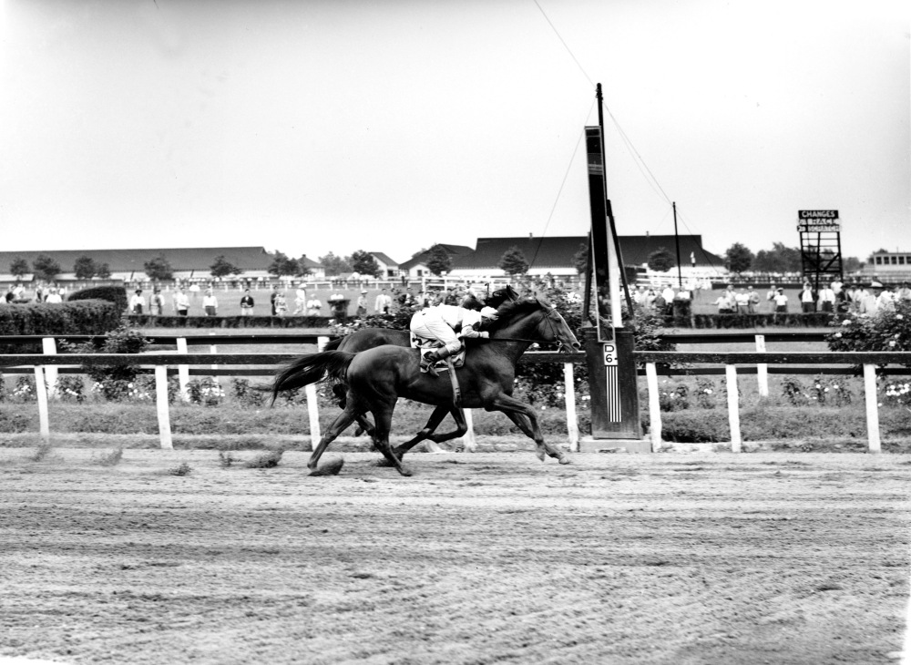 Seabiscuit leads War Admiral in the first turn of their famous match race at Pimlico Race Track in Maryland, US in 1938. Ridden by jockey George Woolf as the normal jockey Red Pollard was hurt, the underdog and far small Seabiscuit beat jockey Charles Kurtsinger and War Admiral handily in a much publicized race. The news painted it as the little guy taking on ridiculous odds, and was gobbled up by the public who had just started to get out of the Great Depression. The terrific film Seabiscuit depicts these events.