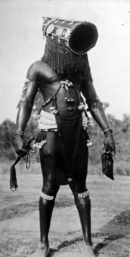 A tribal dancer in a traditional outfit poses for a picture before his routine in Ivory Coast in 1947.