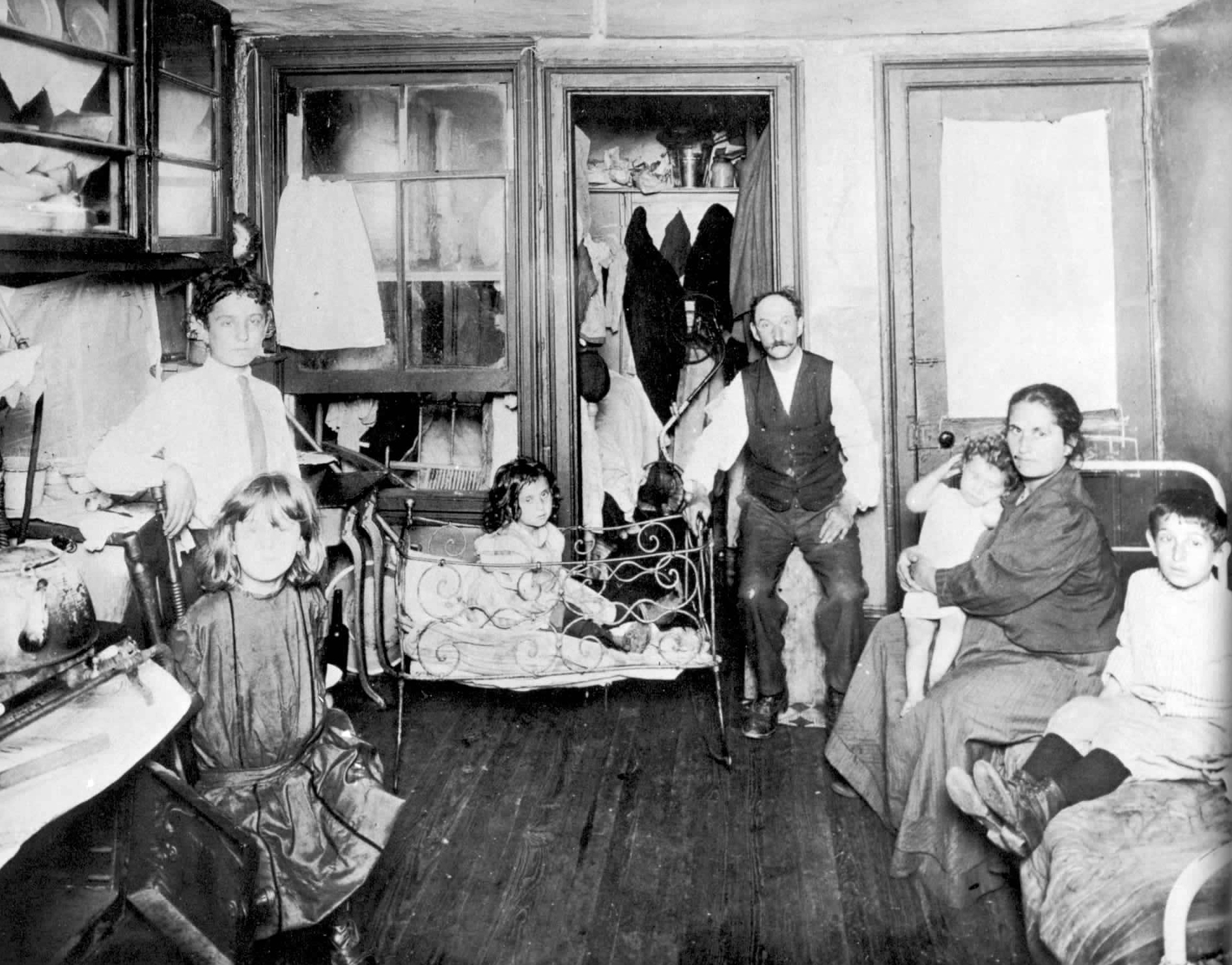 A family living in their 1 room slum apartment in NYC, US in 1890.