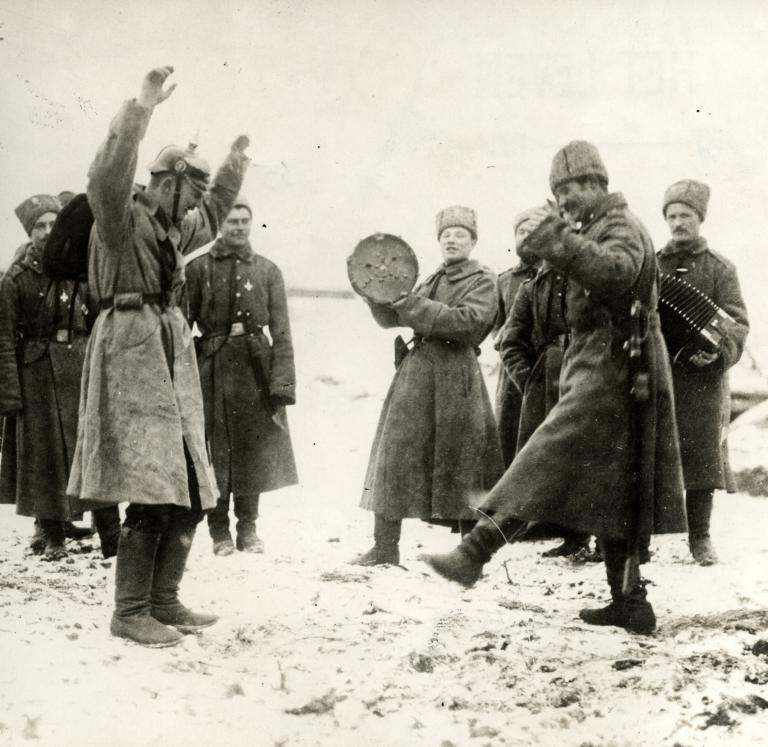 Russian soldiers teaching a captured German soldier the Cossack Dance somewhere on the Eastern Front in 1915.