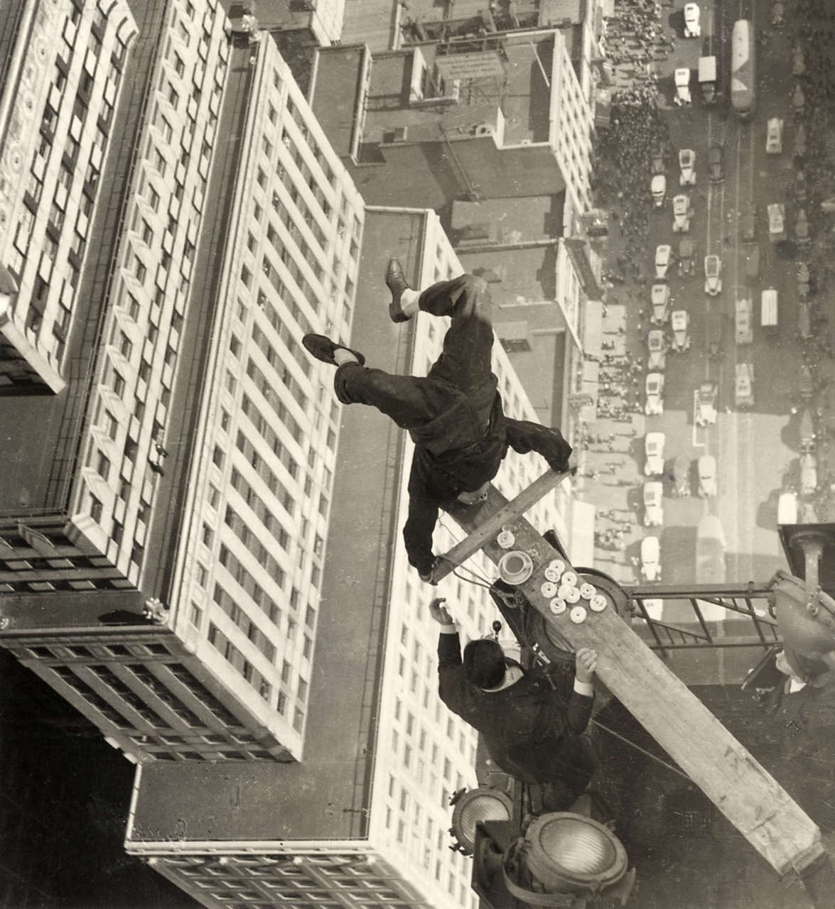 A man balances on a piece of wood at the edge of a skyscraper in Chicago, US in 1938.
