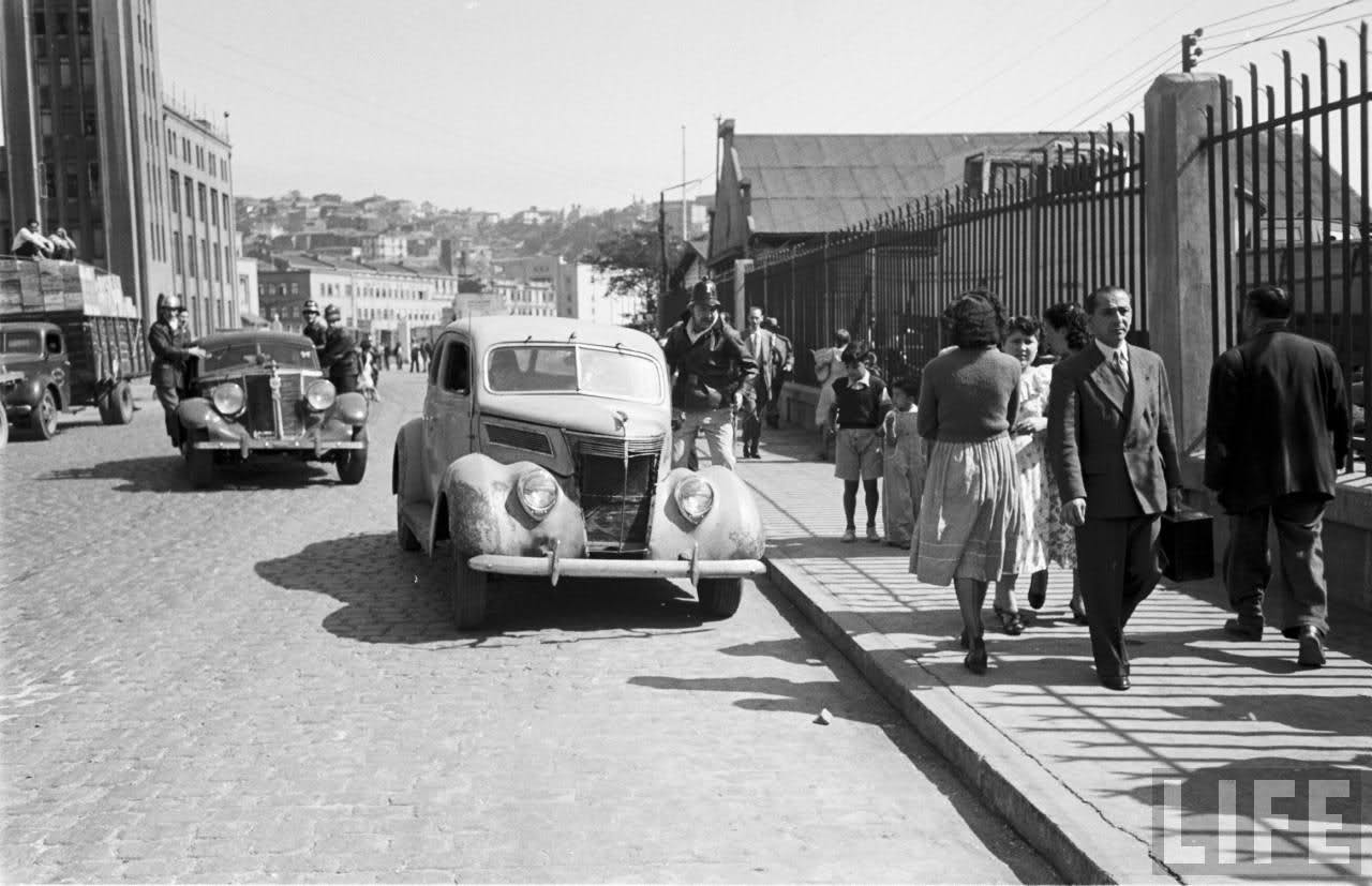 Life Magazine documents firefighters responding to a call at the docks in Valparaiso, Chile in 1950. Normal everyday citizens would pitch in and assist as the fire department was sometimes not equipped for the tasks.