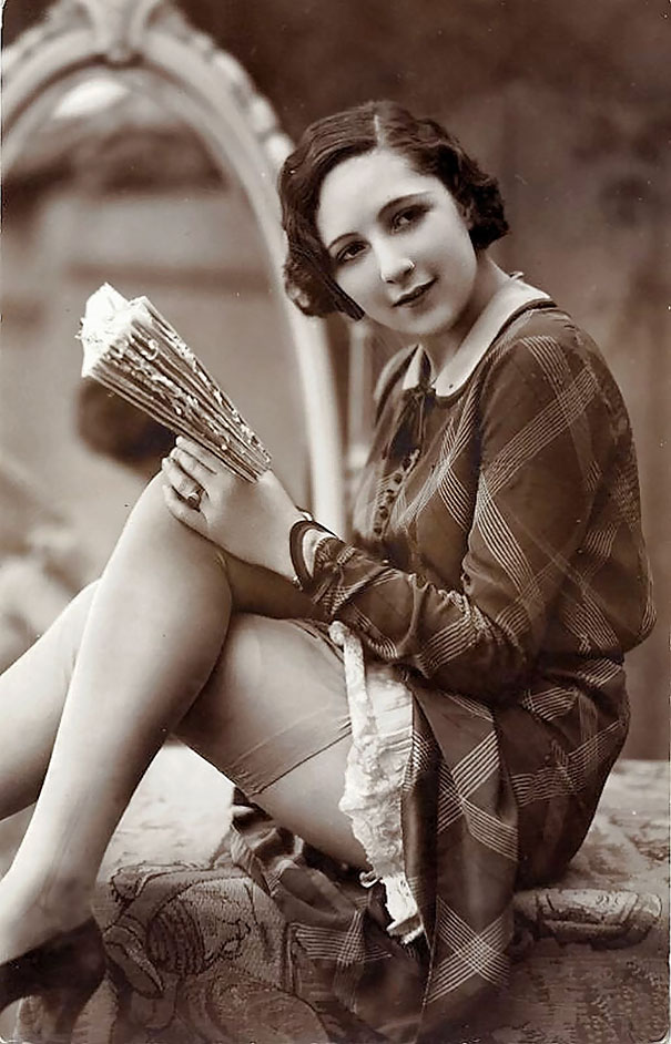 A French model posing for sexy pictures that were part of a series of pictures added to postcards in Paris in the 1920s.