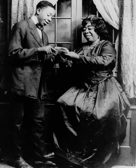 Gertrude "Ma Rainey" Pridgett sharing lyrics with a colleague in 1922. She was one of the first major female blues singers in Harlem, US, and also one of the first openly gay entertainers. She even boldly put hints at her sexuality into her lyrics. She broke ground and would not be denied success. She is a very interesting person to read up on.