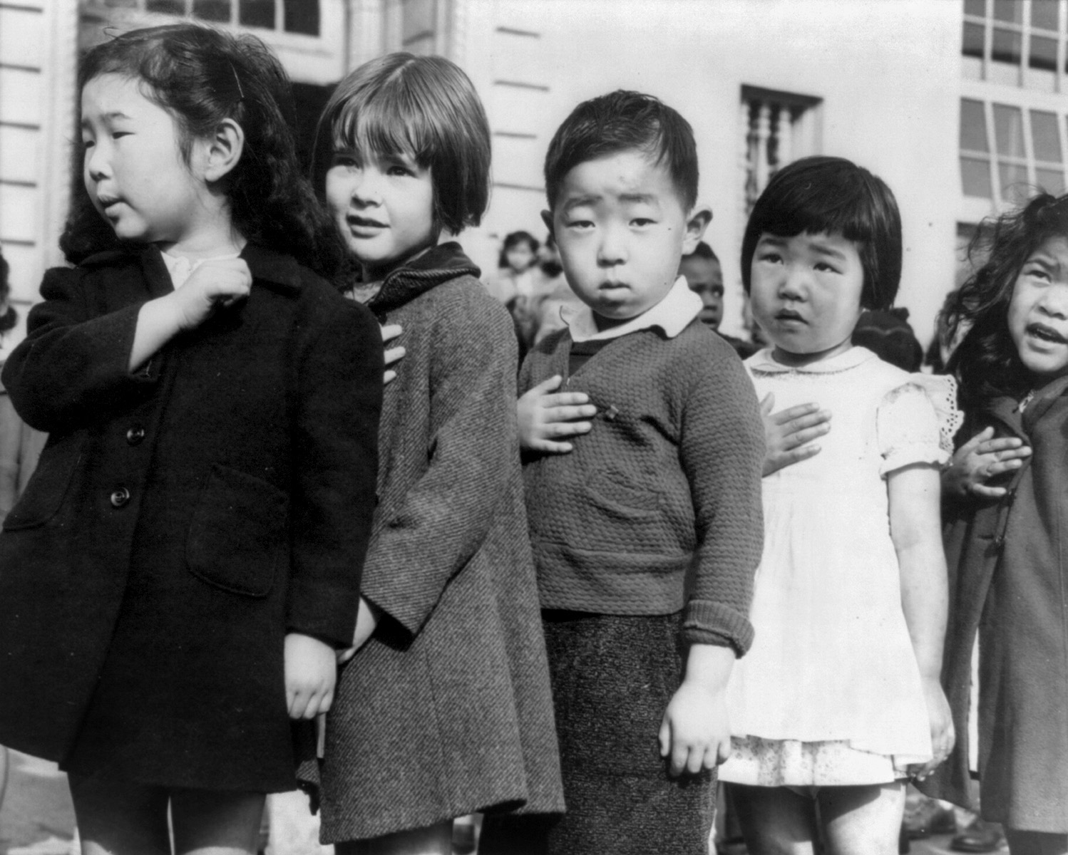 School children pledge allegiance to the American flag in San Francisco, US, in 1941. Within a year, the 3 Japanese American children in this picture (and any others in the school) would be removed and put in internment camps for most of the duration of the war. Up to 500,000 Japanese Americans were put in camps by US officials, regardless of what generation of Japanese American they were or even if they were US citizens. If you had a Japanese background, you most likely found yourself in a camp during WWII.