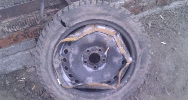 Redneck car repair of bending those rims to fit the tire.